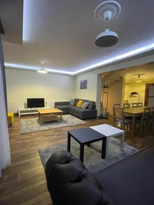 a living room with a couch and a table at Sultan Villa, Merkez Mahallesi Dogu Sirti Caddesi Sultan Sitesi H-2 in Kadıköy