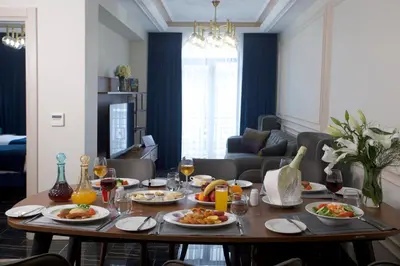 a table with plates of food on it in a living room at Princely Suites Nişantaşı in Istanbul