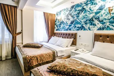 a hotel room with two beds and a mural at Lazz City Hotel in Istanbul