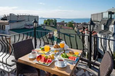 a table with food and fruit on a balcony at Lynda Hotel in Istanbul