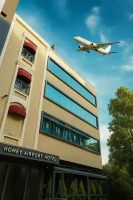 an airplane flying over a honey airport hotel at Homey AirPort Hotel in Arnavutköy