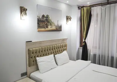a bedroom with a bed with white sheets and pillows at Mar Suite in Istanbul