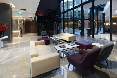 a lobby with couches and chairs in a building at Dedeman Kartepe Kocaeli in Kocaeli