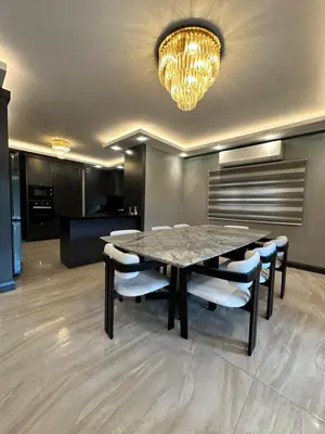 a dining room with a table and chairs and a chandelier at SAPANCA ALHARRAN VILLA in Sapanca