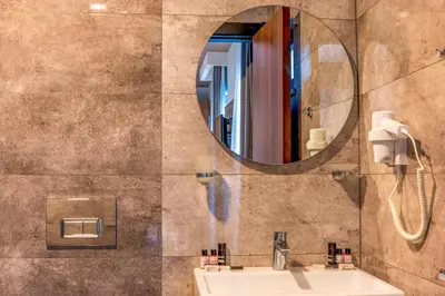 a bathroom with a sink and a mirror at Görükle Alpaş Yaşam Hotel in Bursa