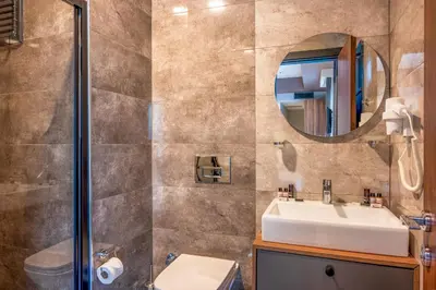 a bathroom with a sink and a mirror at Görükle Alpaş Yaşam Hotel in Bursa