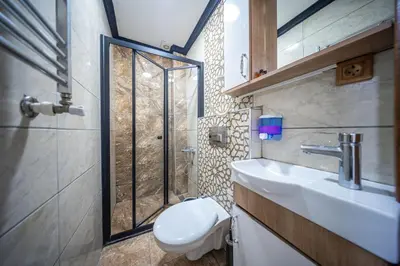 a bathroom with a toilet and a sink and a shower at LAOS OTEL in Istanbul