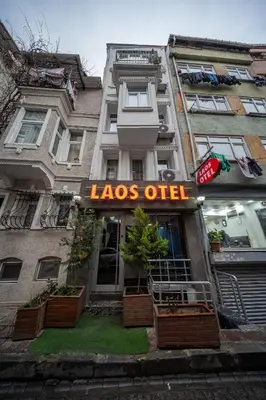 a large building with a sign that reads loos outlet at LAOS OTEL in Istanbul