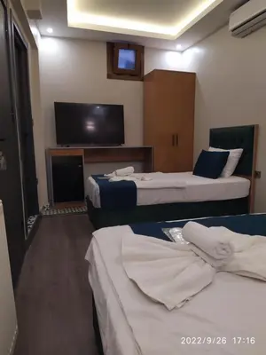 a hotel room with two beds and a flat screen tv at THE MOSS Hotel in Istanbul