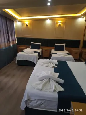 a room with four beds with white towels on them at THE MOSS Hotel in Istanbul