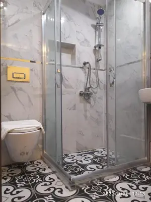 a bathroom with a shower and a toilet at THE MOSS Hotel in Istanbul