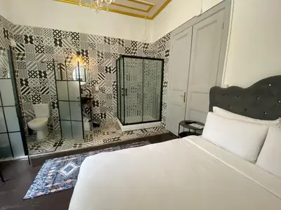 a bedroom with a bed and a bathroom with a mirror at No16 Ada in Adalar