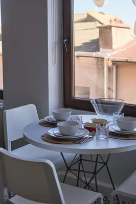 a white table with plates and bowls on it at Sunflower Apartments in Istanbul