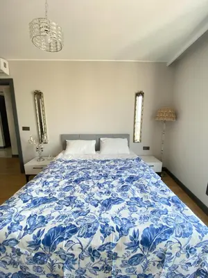 a bedroom with a bed with a blue and white comforter at Luxury Duplex with Terrace Apartment by Siena Suites in Istanbul