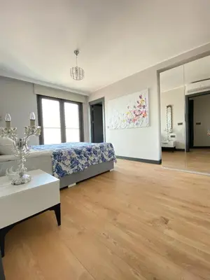a bedroom with a bed and a table and a mirror at Luxury Duplex with Terrace Apartment by Siena Suites in Istanbul