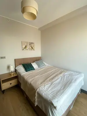 a bedroom with a large bed with a night stand at Luxury Duplex with Terrace Apartment by Siena Suites in Istanbul