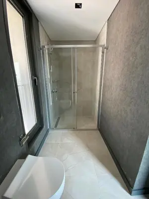 a bathroom with a shower stall and a toilet at Luxury Duplex with Terrace Apartment by Siena Suites in Istanbul