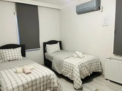 a bedroom with two beds with blankets and a tv at Sapanca Manzara Villa 2 Isıtma Havuzlu in Sapanca