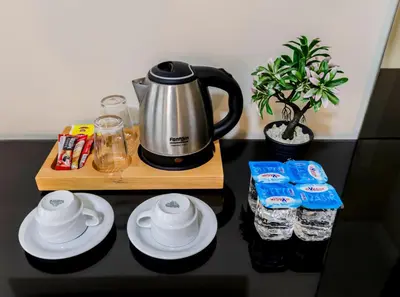 a table with a coffee maker and water bottles at La Pera Suites Hotel in Istanbul