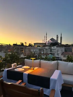 a table and a couch with a view of a city at sahar sultan hotel in Istanbul