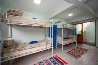 a room with three bunk beds in a room at XALİLA HOSTEL & CAFE LADİES ROOM in Istanbul