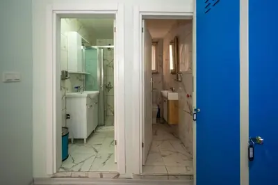 a bathroom with a sink and a mirror at XALİLA HOSTEL & CAFE LADİES ROOM in Istanbul