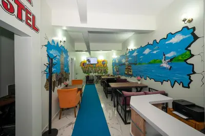 a dining room with a mural of a river on the wall at XALİLA HOSTEL & CAFE LADİES ROOM in Istanbul