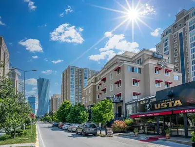 a city street with cars parked on the street at The Gate Ataşehir Finance Centre in Istanbul