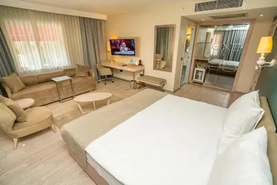 a bedroom with a large bed and a living room at The Gate Ataşehir Finance Centre in Istanbul