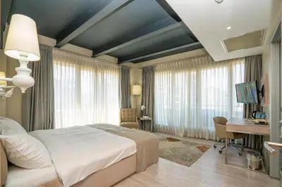 a bedroom with a large bed and a desk and a desk at The Gate Ataşehir Finance Centre in Istanbul