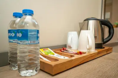 a bottle of water on a wooden tray next to a coffee maker at The Gate Ataşehir Finance Centre in Istanbul