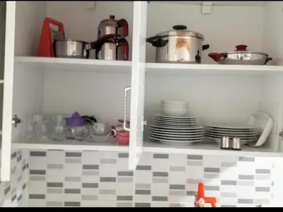 a kitchen shelf with dishes and pots and pans at Golden Life GL in Istanbul