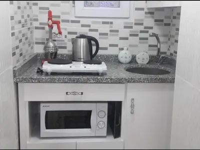 a kitchen counter with a microwave and a sink at Golden Life GL in Istanbul
