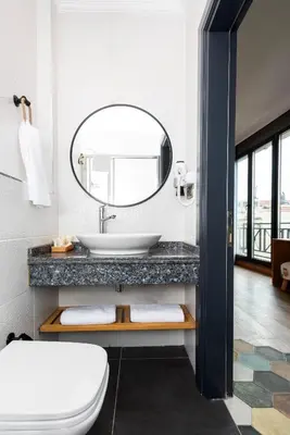 a bathroom with a sink and a mirror at Istanbul Old City Colorful Houses Balat PETRION Hotel in Istanbul