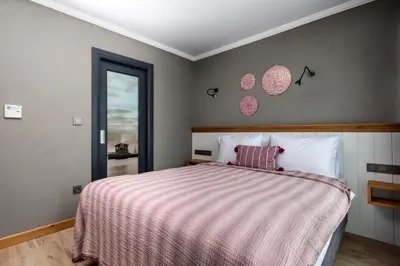 a bedroom with a bed with a pink and white blanket at Istanbul Old City Colorful Houses Balat PETRION Hotel in Istanbul