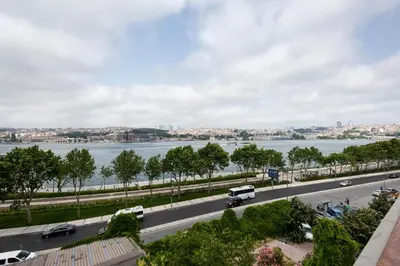a view of a road and a river with cars at Istanbul Old City Colorful Houses Balat PETRION Hotel in Istanbul