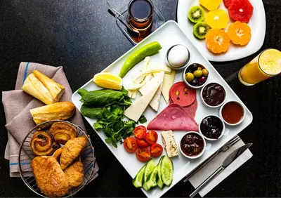 a plate of food with different types of food at Istanbul Old City Colorful Houses Balat PETRION Hotel in Istanbul