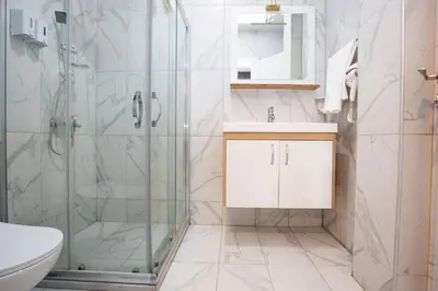 a bathroom with a shower and a sink and a toilet at Taksim Square Leon's Hotel in Istanbul