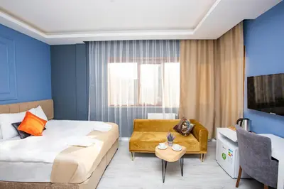 a hotel room with a bed and a couch at Taksim Square Leon's Hotel in Istanbul