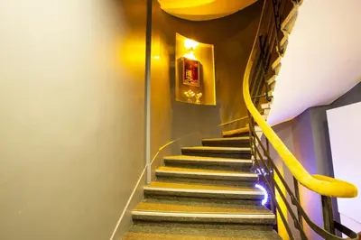 a staircase with a yellow handrail and yellow stairsearch at Taksim Square Leon's Hotel in Istanbul