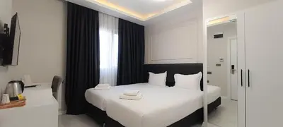 a bedroom with a bed with two towels on it at Taksim Square Leon's Hotel in Istanbul
