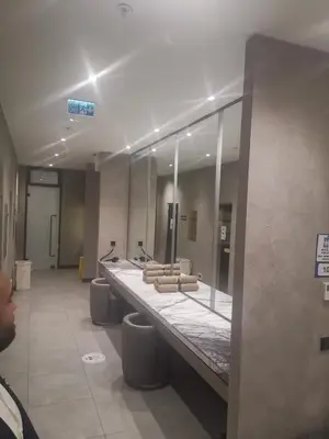 a bathroom with a row of sinks and mirrors at My G yoo Apartment #1 in Istanbul