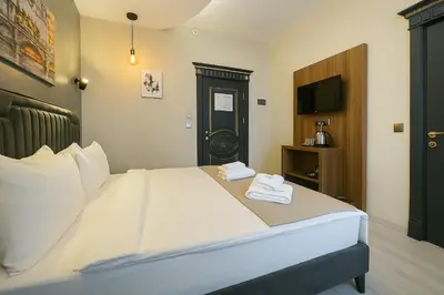 a hotel room with a large bed with two towels at Monezza Avcılar in Istanbul