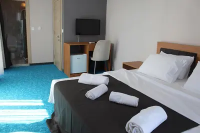 a bedroom with a bed with two towels on it at Silver Continent Hostel in Silivri