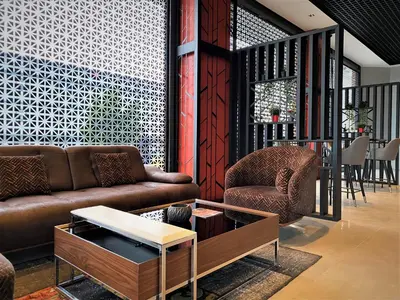 a living room with a couch and a table at World Class Hotel - Istanbul Airport in Arnavutköy