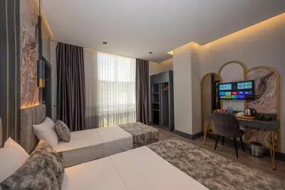 a hotel room with a bed and a desk at World Class Hotel - Istanbul Airport in Arnavutköy