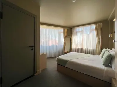a bedroom with a bed and a large window at By Kinyas Hotel in Istanbul