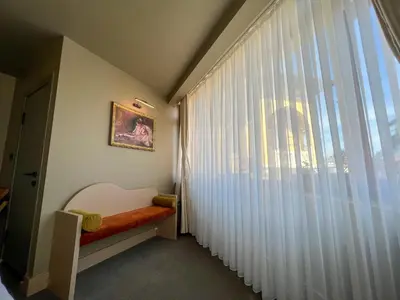 a room with a window with white curtains and a bench at By Kinyas Hotel in Istanbul