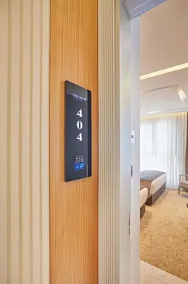 a hotel room with a clock on the wall at THE HUBİ HOTEL in Istanbul