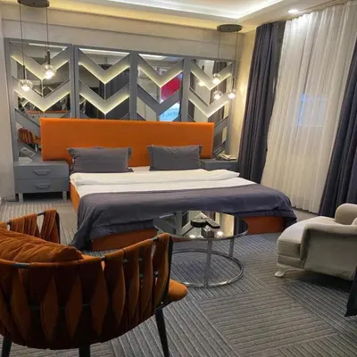 a bedroom with a bed and a couch and a chair at Valeron Suit Premium in Istanbul